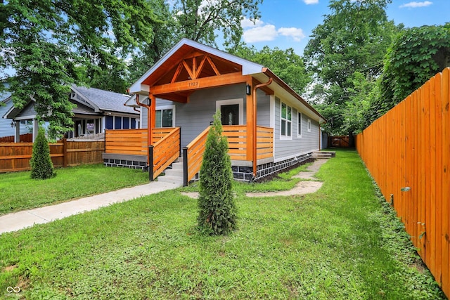 1923 N Parker Ave, Indianapolis, IN 46218 - shotgun-style home with a fenced backyard and a deck