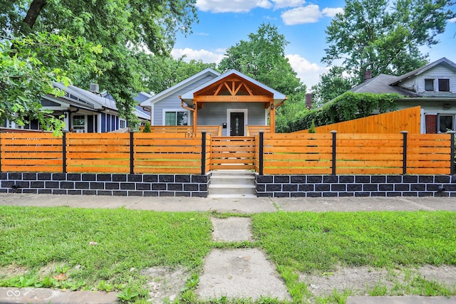 1923 N Parker Ave, Indianapolis, IN 46218 - bungalow-style house with a fenced front yard and a gate