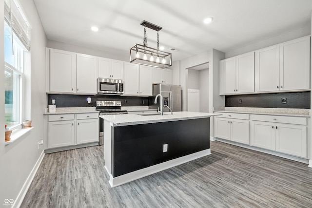 7225 Lockford S, Avon, IN 46123 - kitchen with stainless steel appliances, light wood-type flooring, white cabinets, recessed lighting, and hanging light fixtures