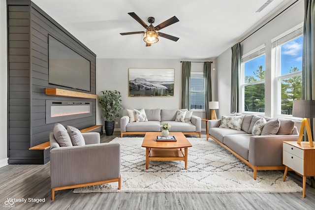 7225 Lockford S, Avon, IN 46123 - living area featuring a fireplace, wood finished floors, and a ceiling fan