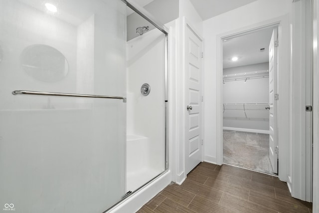 7225 Lockford S, Avon, IN 46123 - bathroom with a stall shower, a spacious closet, wood finished floors, and recessed lighting
