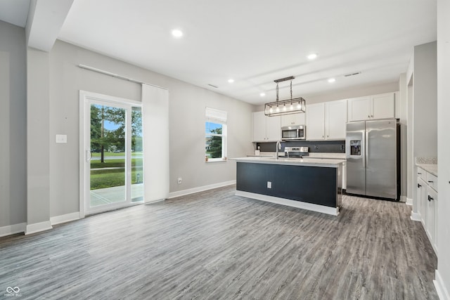7225 Lockford S, Avon, IN 46123 - kitchen with stainless steel appliances, light countertops, wood finished floors, white cabinets, and recessed lighting