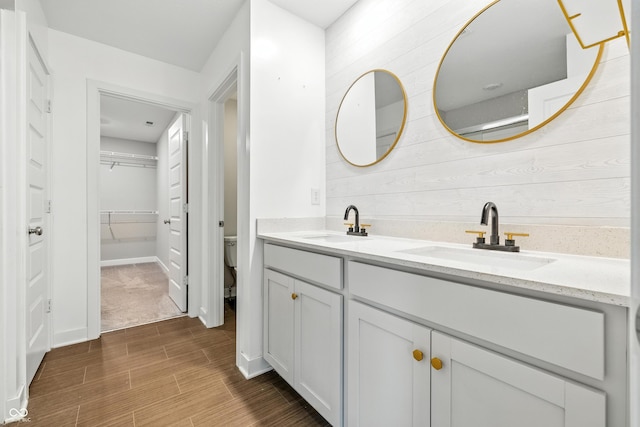7225 Lockford S, Avon, IN 46123 - bathroom with double vanity, wood finished floors, wooden walls, and a walk in closet