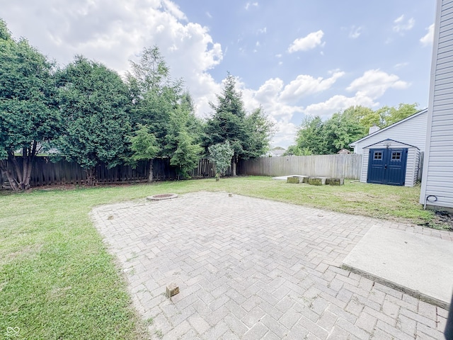 1381 Harrison Dr, Greenwood, IN 46143 - fenced backyard featuring a patio area, an outdoor fire pit, and a shed