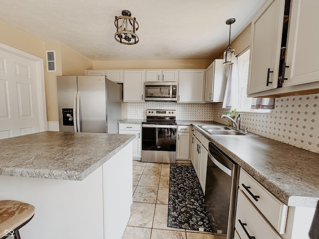 1381 Harrison Dr, Greenwood, IN 46143 - kitchen featuring stainless steel appliances, backsplash, hanging light fixtures, and light tile patterned flooring