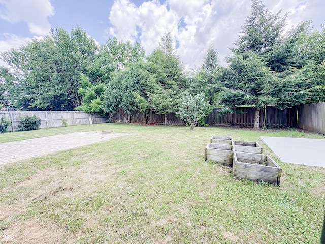 1381 Harrison Dr, Greenwood, IN 46143 - fenced backyard with a garden and a patio