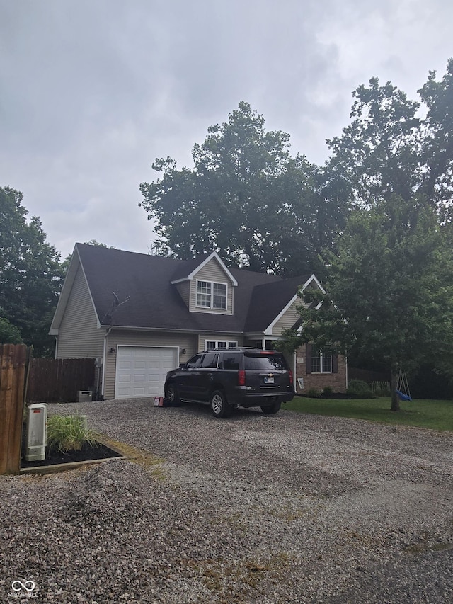 310 Tiffany Ln, North Vernon, IN 47265 - traditional-style house with dirt driveway and an attached garage