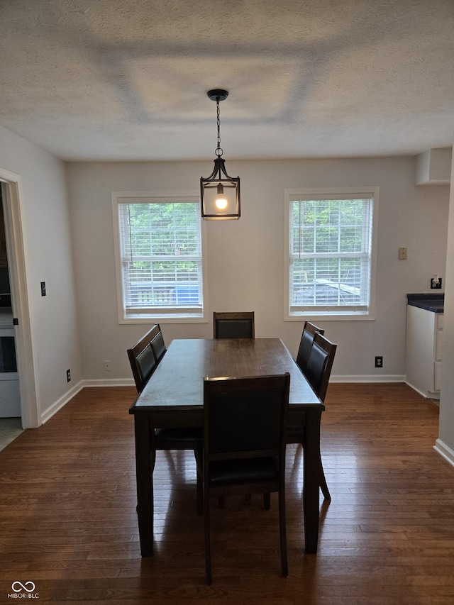 310 Tiffany Ln, North Vernon, IN 47265 - dining room featuring healthy amount of natural light, dark wood-style flooring, and a textured ceiling