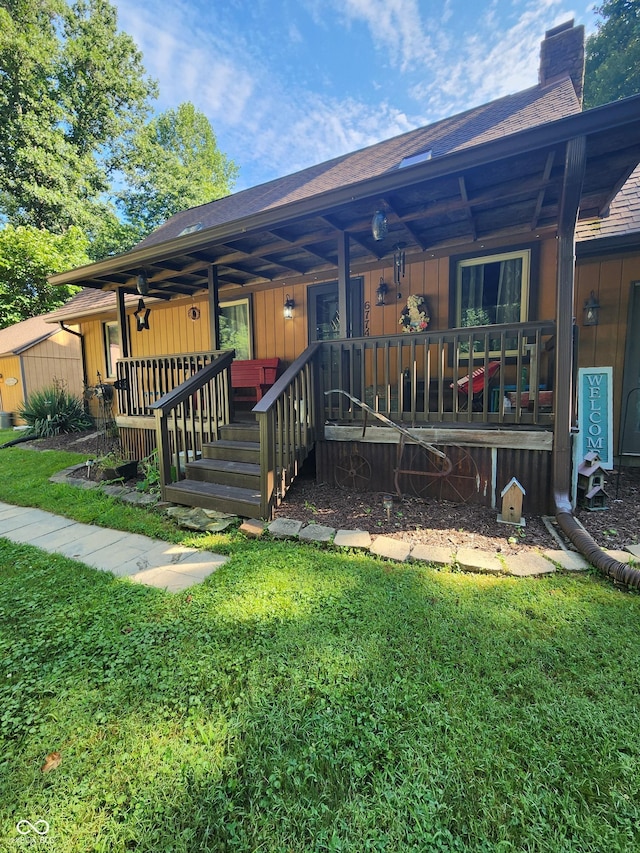 6774 S Becks Grove Rd, Freetown, IN 47235 - back of house featuring a chimney, a shingled roof, a yard, and a porch