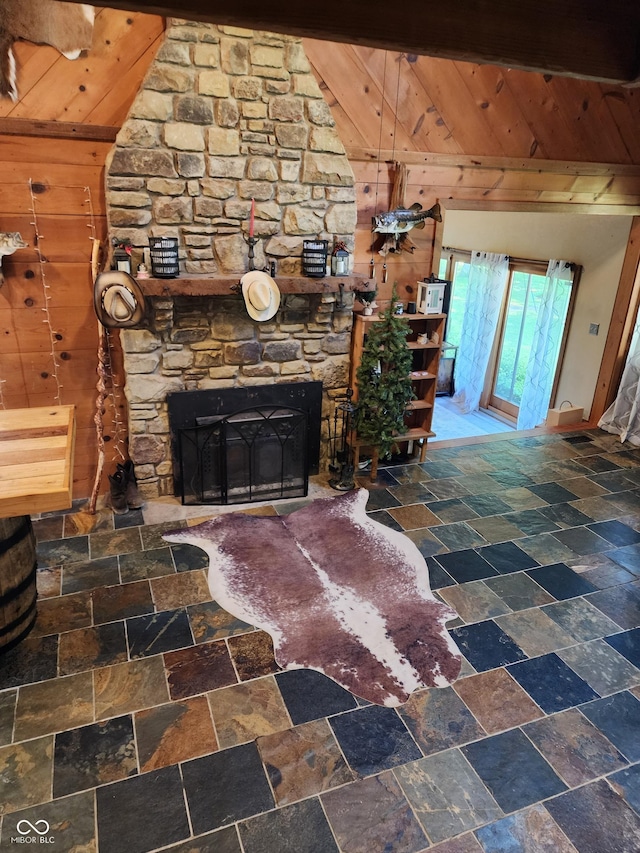 6774 S Becks Grove Rd, Freetown, IN 47235 - living area featuring lofted ceiling, wooden ceiling, stone tile flooring, wooden walls, and a stone fireplace