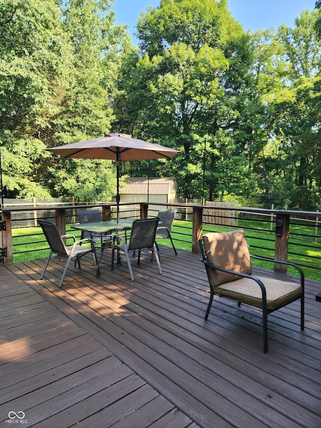 6774 S Becks Grove Rd, Freetown, IN 47235 - wooden terrace featuring outdoor dining space, a yard, and an outbuilding