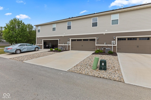 7265 Governors Row, Avon, IN 46123 - view of front of property featuring brick siding, a garage, and concrete driveway