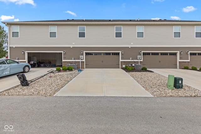 7265 Governors Row, Avon, IN 46123 - view of property featuring brick siding, an attached garage, and driveway
