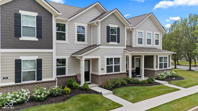 7265 Governors Row, Avon, IN 46123 - townhome / multi-family property with brick siding and a front lawn