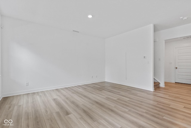 7265 Governors Row, Avon, IN 46123 - unfurnished room featuring light wood-style flooring, stairway, and recessed lighting