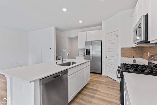 7265 Governors Row, Avon, IN 46123 - kitchen with stainless steel appliances, a center island with sink, tasteful backsplash, white cabinets, and light countertops