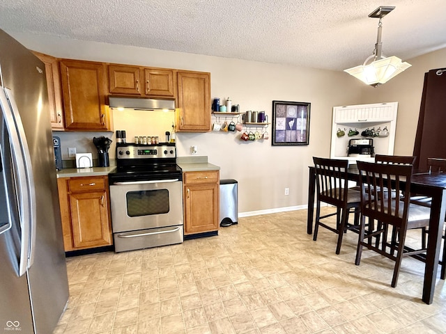 6309 Monteo Dr, Indianapolis, IN 46217 - kitchen featuring stainless steel appliances, brown cabinets, under cabinet range hood, a textured ceiling, and light countertops