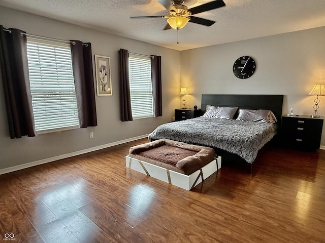 6309 Monteo Dr, Indianapolis, IN 46217 - bedroom with wood finished floors, multiple windows, a textured ceiling, and a ceiling fan