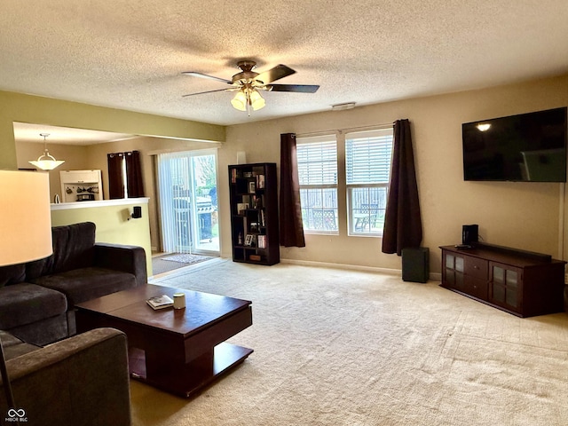 6309 Monteo Dr, Indianapolis, IN 46217 - living area with carpet, a ceiling fan, and a textured ceiling