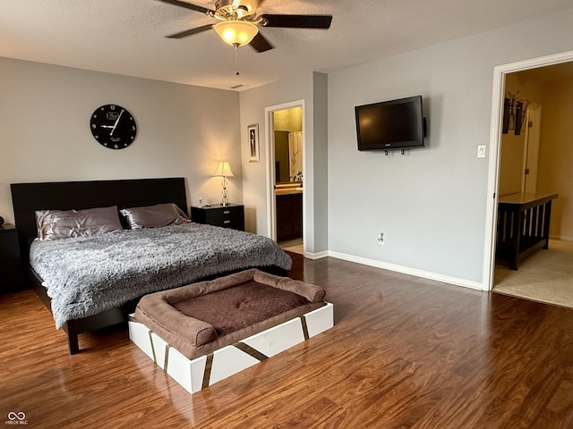6309 Monteo Dr, Indianapolis, IN 46217 - bedroom with wood finished floors, ceiling fan, ensuite bathroom, and a textured ceiling