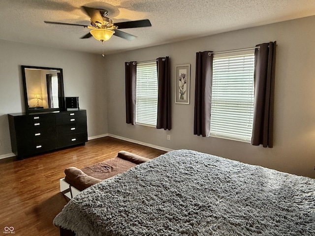 6309 Monteo Dr, Indianapolis, IN 46217 - bedroom featuring dark wood-type flooring, ceiling fan, and a textured ceiling