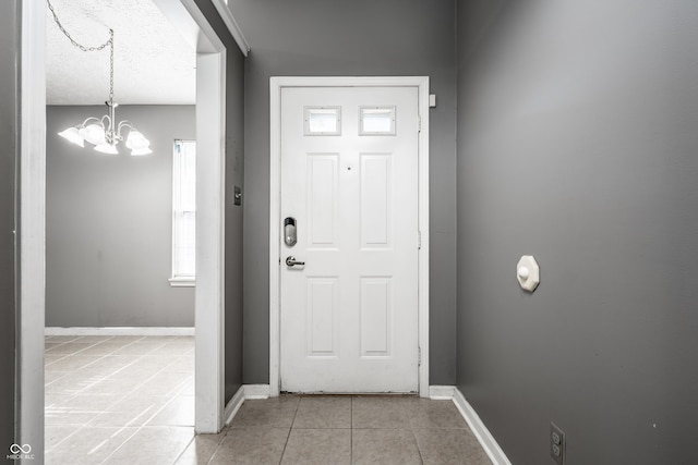 12956 Shandon Ln, Fishers, IN 46038 - entryway featuring light tile patterned flooring and a chandelier