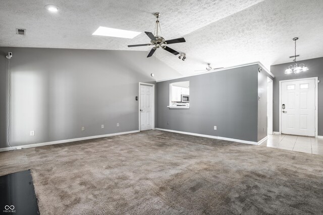 12956 Shandon Ln, Fishers, IN 46038 - unfurnished living room with a ceiling fan, carpet flooring, a chandelier, vaulted ceiling, and a textured ceiling