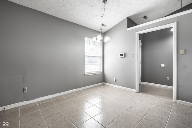 12956 Shandon Ln, Fishers, IN 46038 - empty room with tile patterned floors, a textured ceiling, a chandelier, and vaulted ceiling