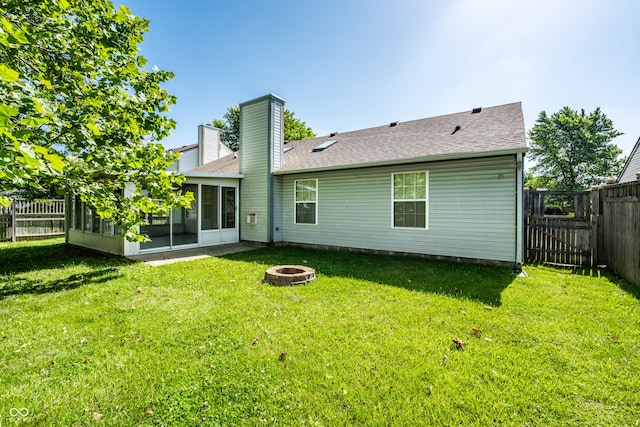 12956 Shandon Ln, Fishers, IN 46038 - back of house with a fire pit, a sunroom, a fenced backyard, a chimney, and a shingled roof