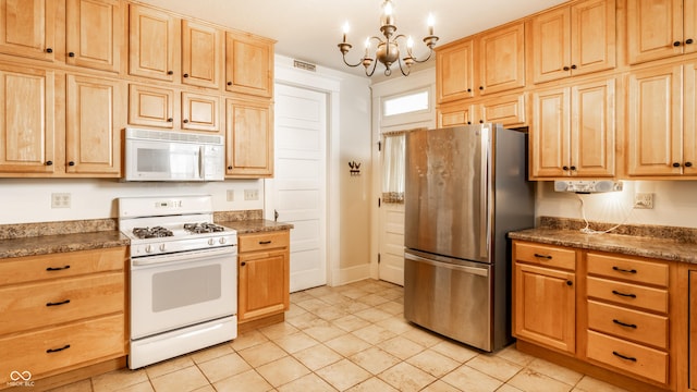 429 W Washington St, Shelbyville, IN 46176 - kitchen with white appliances, a chandelier, light brown cabinetry, and light tile patterned floors