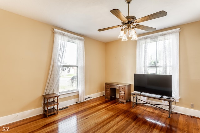 429 W Washington St, Shelbyville, IN 46176 - living area with hardwood / wood-style floors, healthy amount of natural light, and a ceiling fan