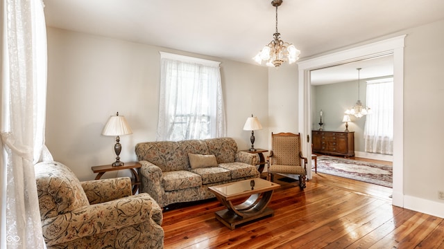 429 W Washington St, Shelbyville, IN 46176 - living area featuring a chandelier, wood-type flooring, and plenty of natural light