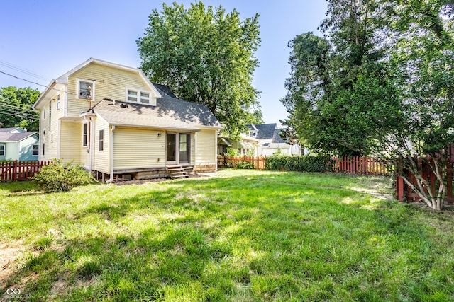 429 W Washington St, Shelbyville, IN 46176 - rear view of property with entry steps, a fenced backyard, and roof with shingles