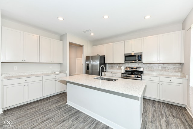 2234 S Bingham Pl, New Palestine, IN 46163 - kitchen featuring stainless steel appliances, wood finished floors, backsplash, an island with sink, and recessed lighting