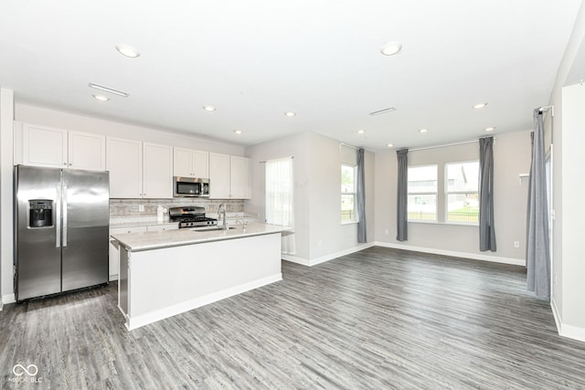 2234 S Bingham Pl, New Palestine, IN 46163 - kitchen with stainless steel appliances, wood finished floors, light countertops, recessed lighting, and tasteful backsplash