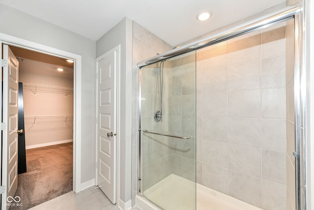 2234 S Bingham Pl, New Palestine, IN 46163 - bathroom with a stall shower, tile patterned flooring, a spacious closet, and recessed lighting