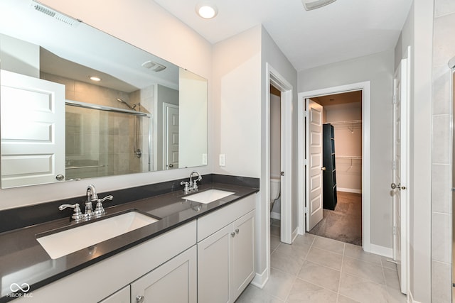2234 S Bingham Pl, New Palestine, IN 46163 - full bathroom featuring a stall shower, double vanity, tile patterned flooring, and a spacious closet