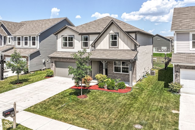 2234 S Bingham Pl, New Palestine, IN 46163 - view of front of property with board and batten siding, driveway, brick siding, a garage, and a front lawn