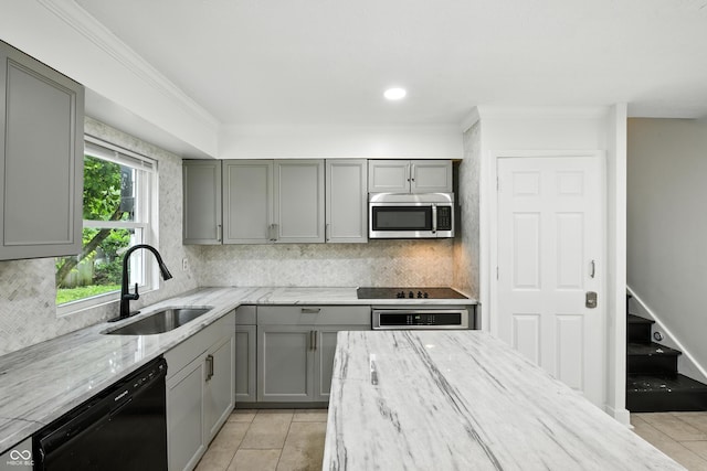 8041 Barry Rd, Indianapolis, IN 46219 - kitchen with gray cabinetry, black appliances, decorative backsplash, light stone countertops, and light tile patterned floors