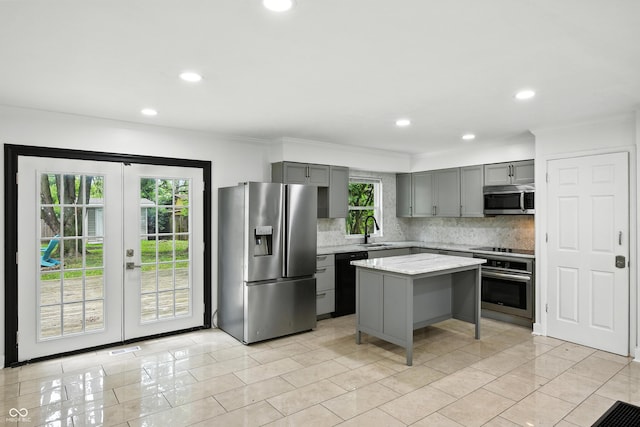 8041 Barry Rd, Indianapolis, IN 46219 - kitchen with appliances with stainless steel finishes, gray cabinets, backsplash, recessed lighting, and ornamental molding