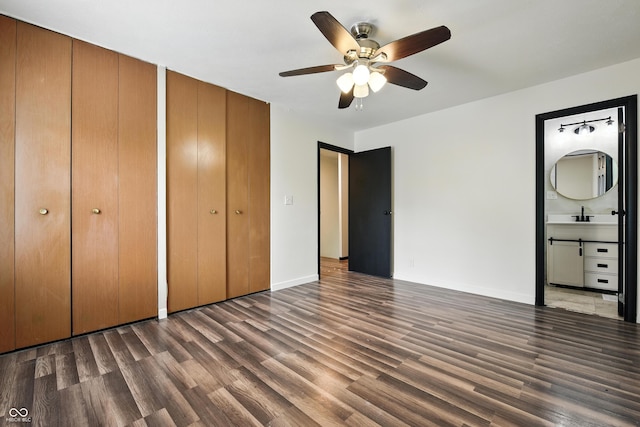 8041 Barry Rd, Indianapolis, IN 46219 - unfurnished bedroom featuring two closets, wood finished floors, connected bathroom, and a ceiling fan