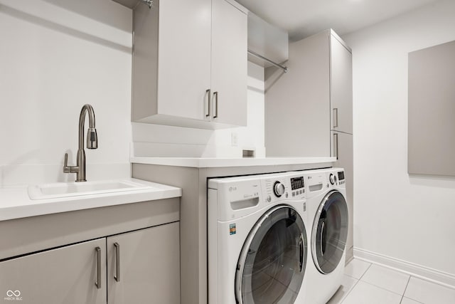 35 E 58th St, Indianapolis, IN 46220 - laundry room featuring washer and clothes dryer, cabinet space, and light tile patterned floors
