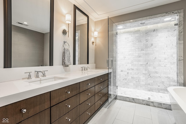 35 E 58th St, Indianapolis, IN 46220 - bathroom featuring crown molding, double vanity, a freestanding tub, a shower stall, and tile patterned flooring