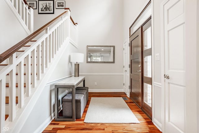 35 E 58th St, Indianapolis, IN 46220 - entrance foyer featuring wood finished floors, a high ceiling, and stairway