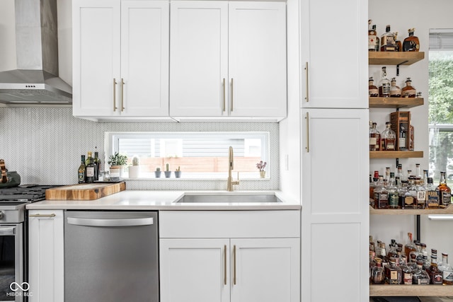 2539 Broadway St, Indianapolis, IN 46205 - kitchen featuring stainless steel appliances, wall chimney range hood, decorative backsplash, and white cabinetry