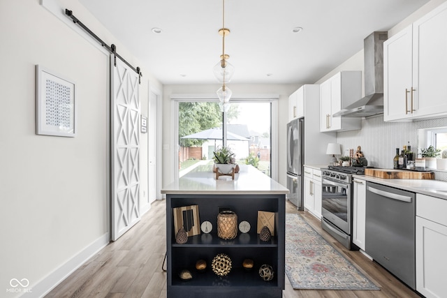 2539 Broadway St, Indianapolis, IN 46205 - kitchen with wall chimney range hood, stainless steel appliances, open shelves, white cabinets, and a barn door