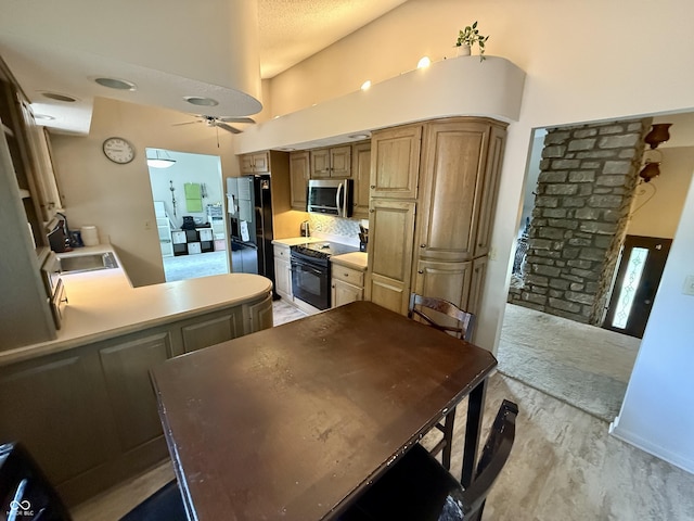 910 Ranch Rd, Connersville, IN 47331 - kitchen with black appliances, ceiling fan, light wood-type flooring, a high ceiling, and light countertops