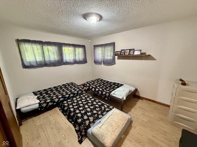 910 Ranch Rd, Connersville, IN 47331 - bedroom featuring wood finished floors and a textured ceiling