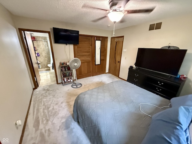 910 Ranch Rd, Connersville, IN 47331 - carpeted bedroom featuring a textured ceiling, a closet, a ceiling fan, and ensuite bathroom