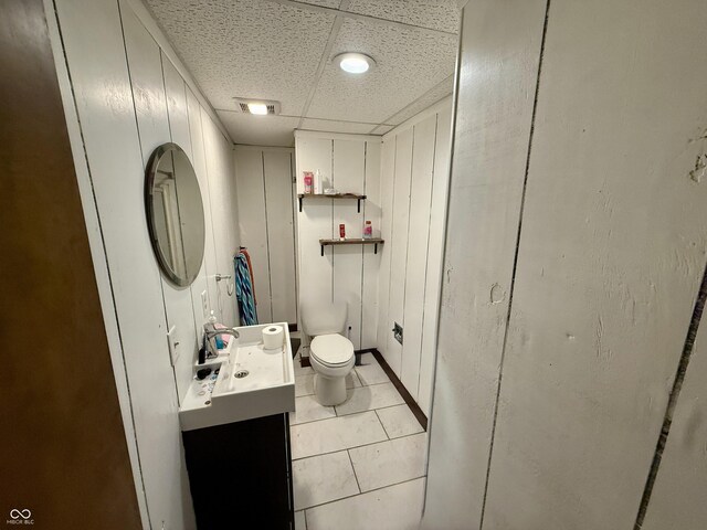910 Ranch Rd, Connersville, IN 47331 - half bath with vanity, a paneled ceiling, and tile patterned floors